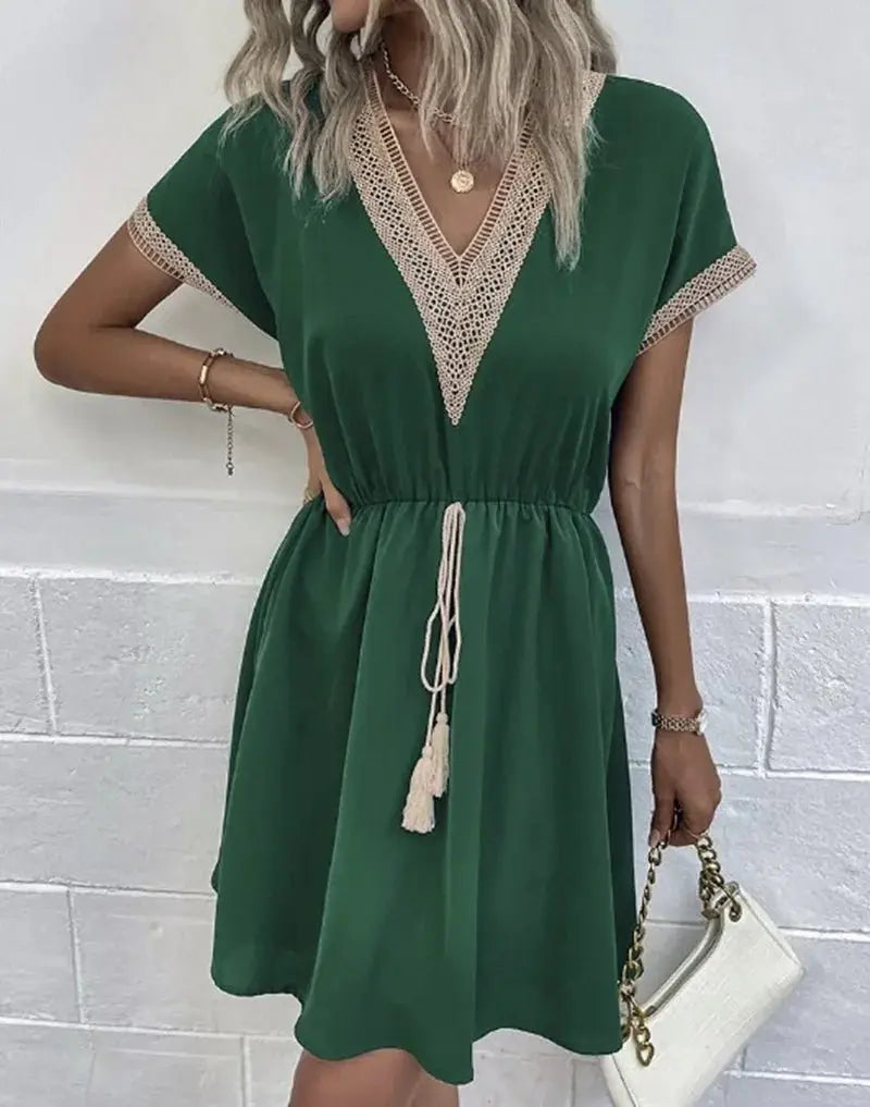 Bohemian V-neck midi dress for women. Features short sleeves, a flattering tie waist, and a comfortable flowy fit.