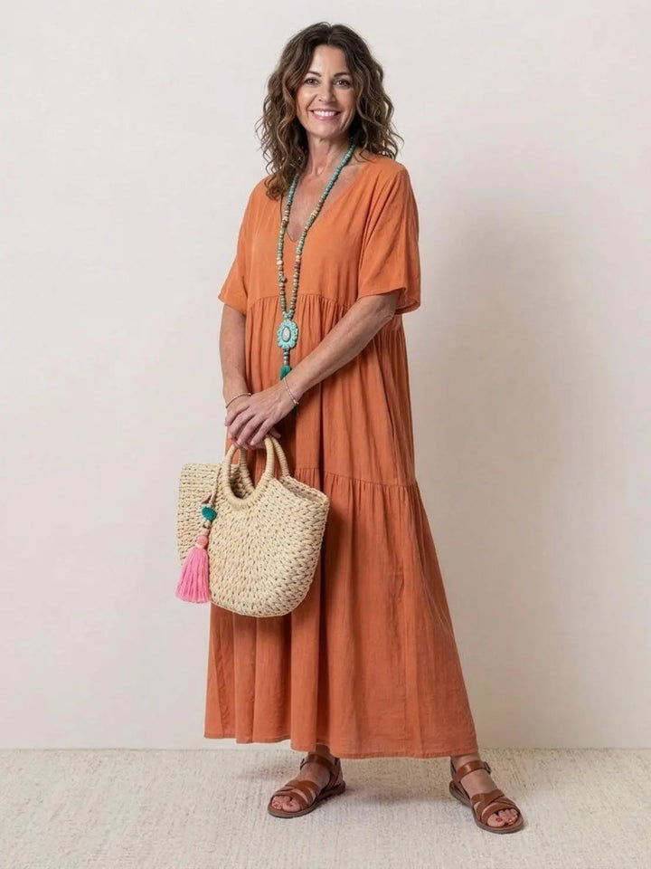 Women's boho V-neck tiered maxi dress with short sleeves, perfect for summer.