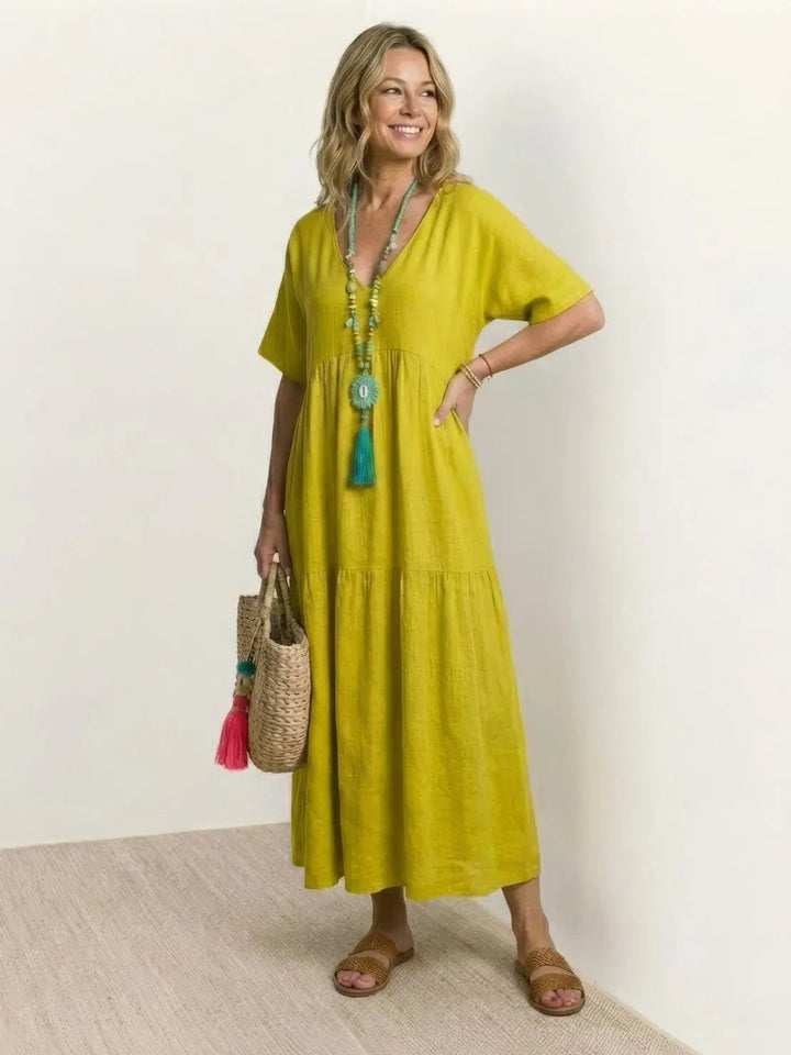 Elegant boho maxi dress for women, V-neck, short sleeves, tiered, ideal for vacation.