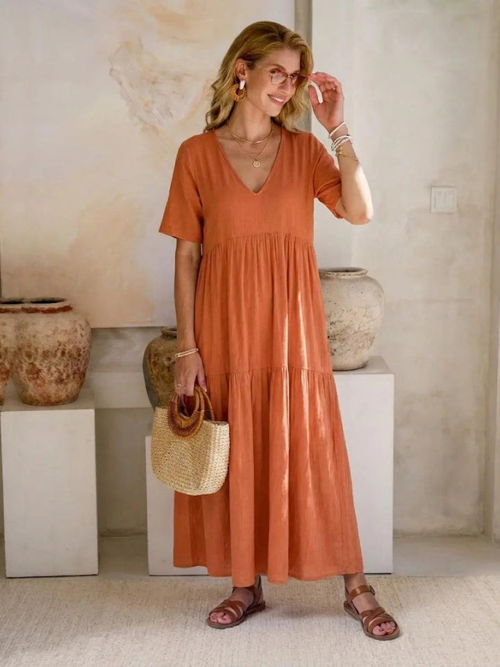 Comfy women's flowy V-neck maxi dress, short sleeves, tiered, summer day outfit.