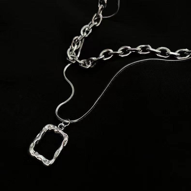 Chunky link gold chain necklace for women, featuring a textured rectangular statement pendant. Trendy bold fashion jewelry.
