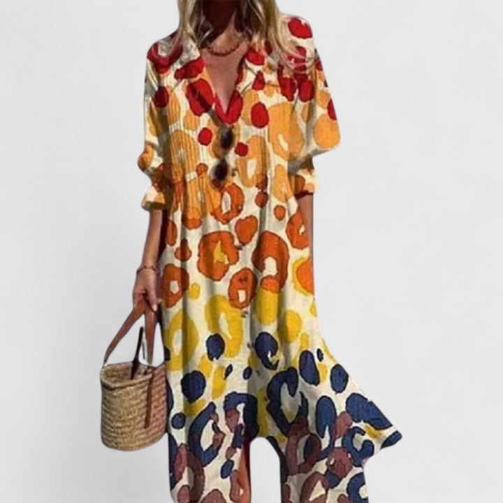 Flowy women's midi dress featuring a vibrant botanical print and stylish button-front design.