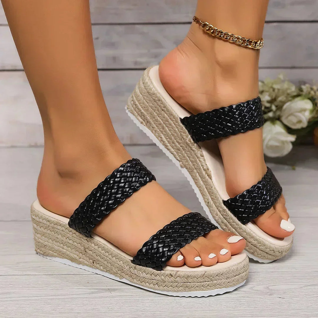 Stylish women's wedge sandals with braided slip-on straps, offering easy wearability.