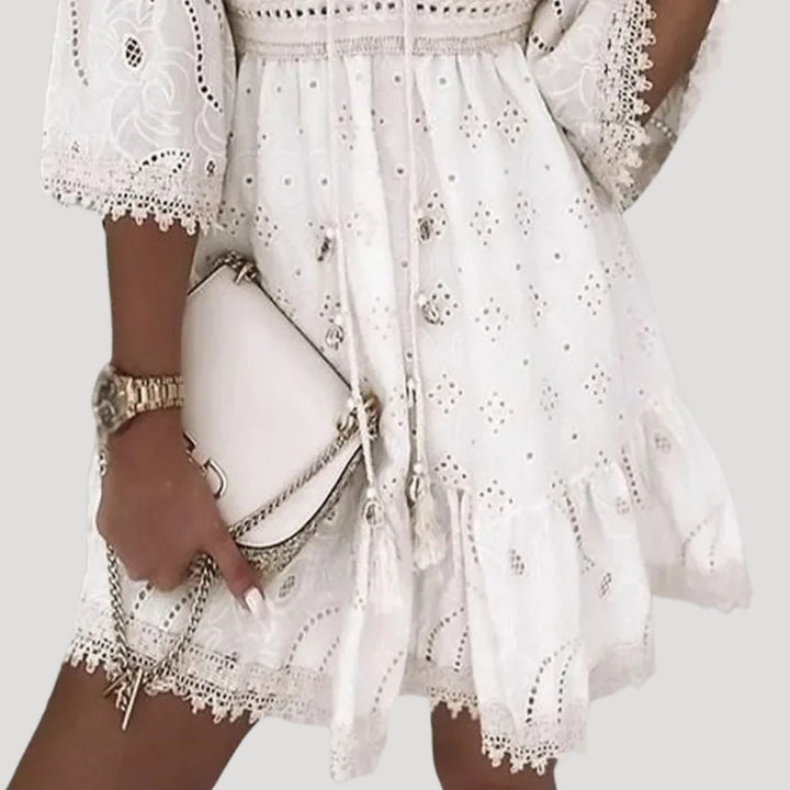 Embroidered boho mini dress for women, featuring intricate details, V-neck, and flared sleeves. Holiday attire.