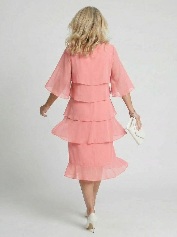 Side profile of the women's flowy midi dress, highlighting its relaxed fit and tiered design.