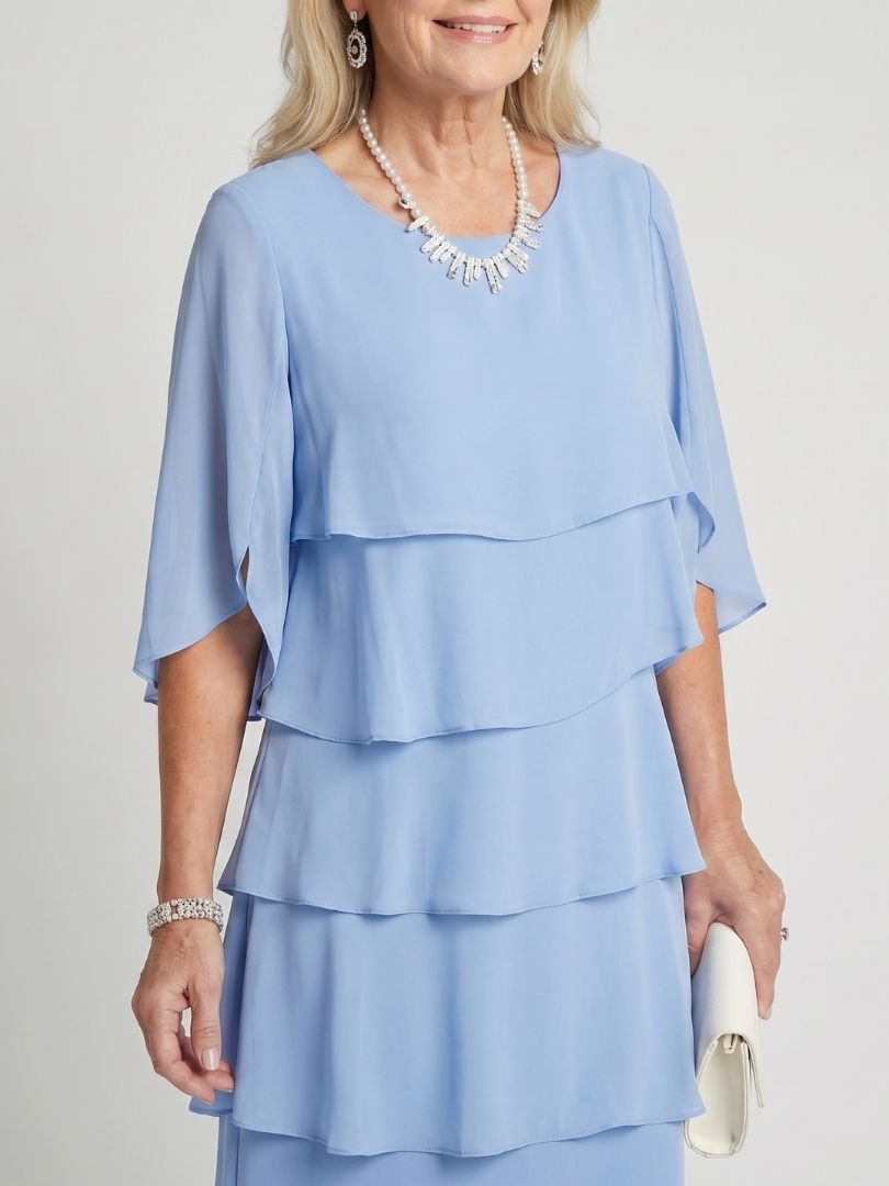Model enjoying the comfortable wear of the relaxed fit women's layered midi dress.