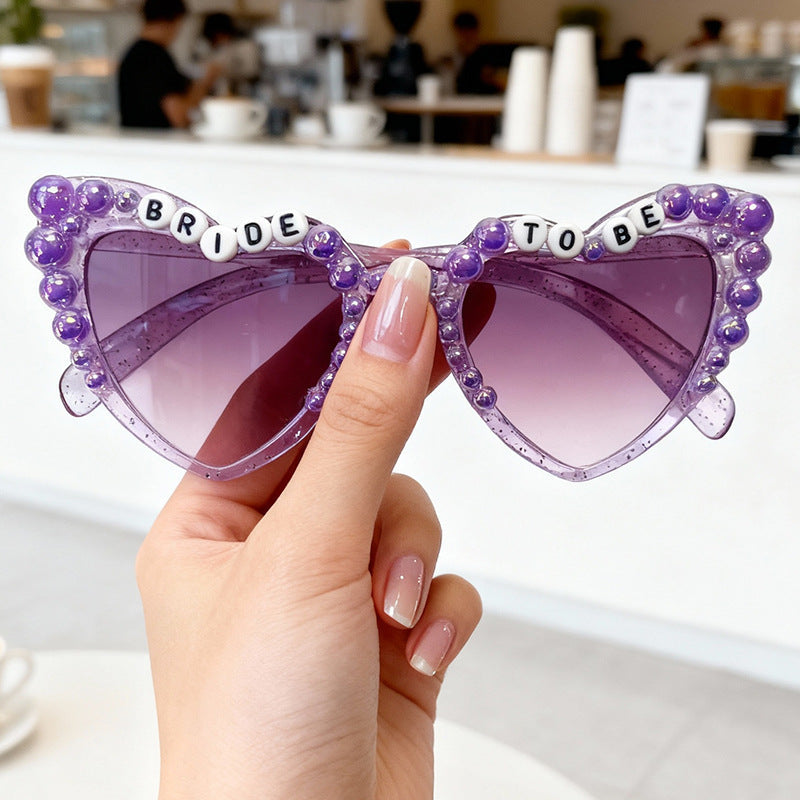 Fashionable women's bridal sunglasses. Cat-eye design with pearls, essential for 'Bride To Be' and wedding party fun. UV400.