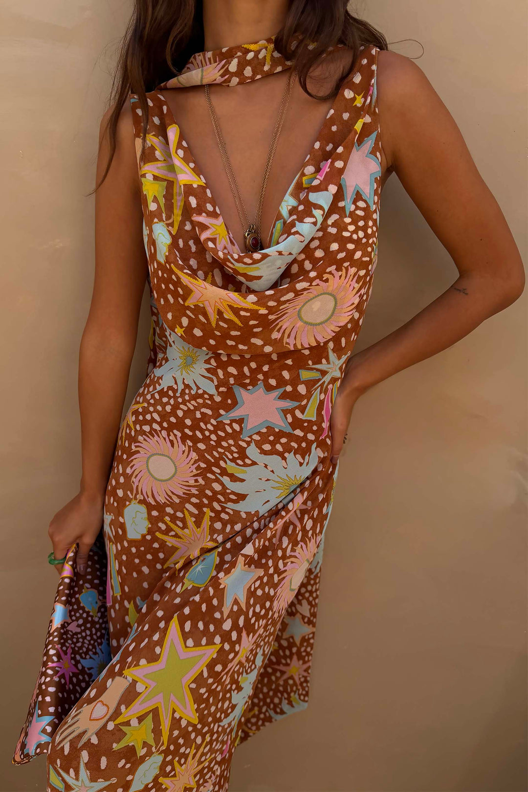 Comfortable women's cowl neck halter dress in brown fawn print, ideal for relaxing resort wear.