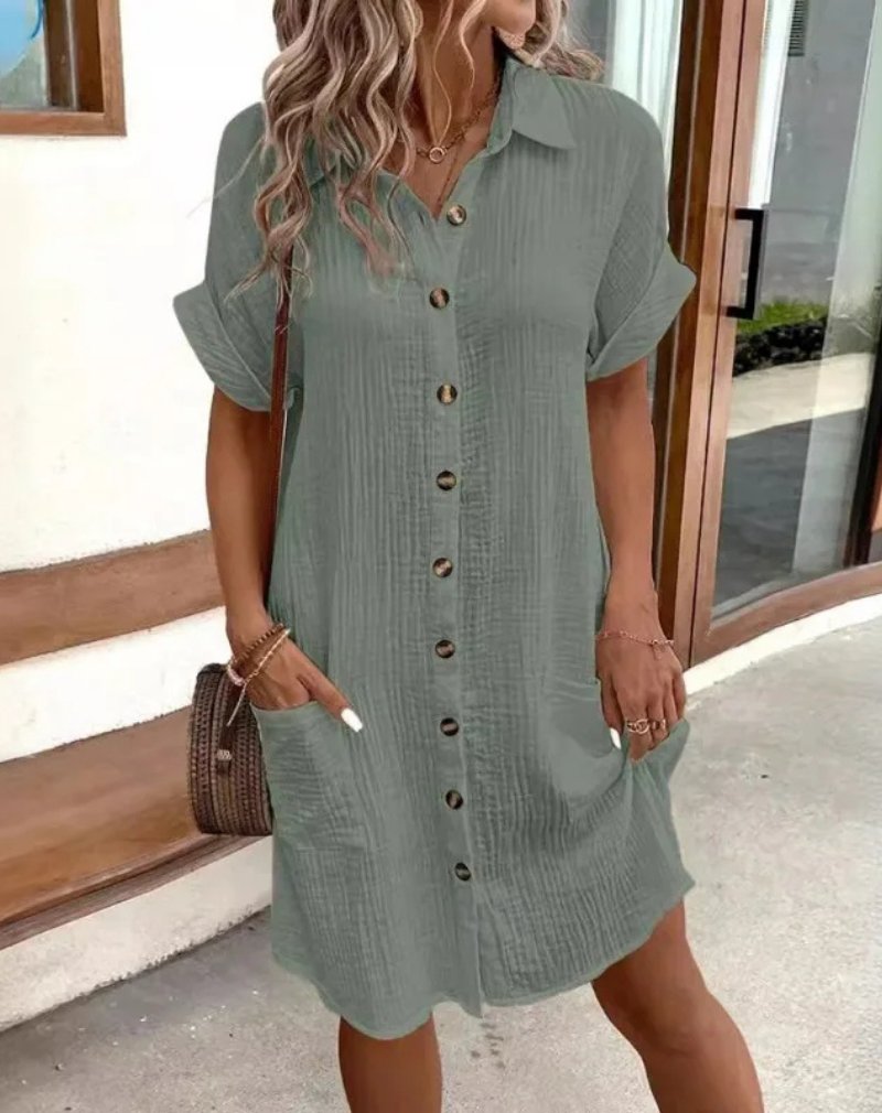 Relaxed fit women's collared shirt dress, short sleeve button-down style, great for summer, beach, or casual outings.