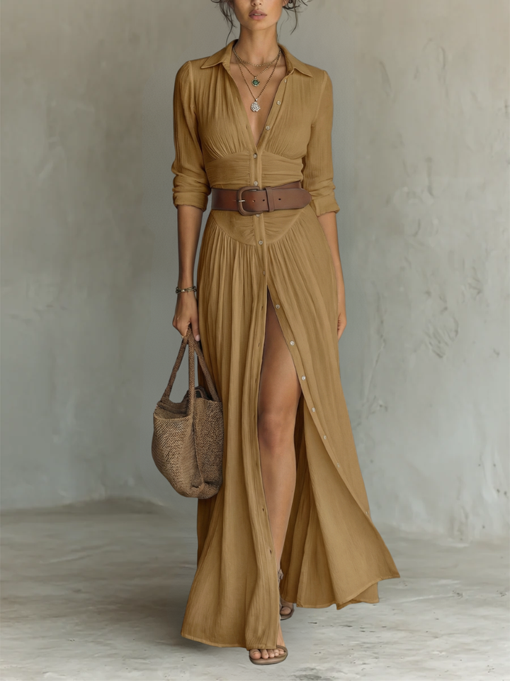 Close-up of a women's button-down maxi dress, long sleeves, collared. Showcases fabric and ruched waist detail.