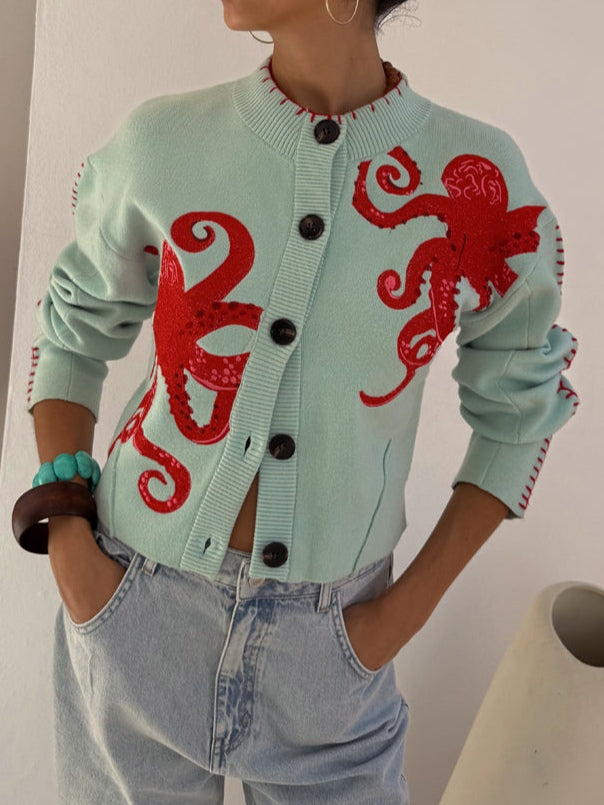 Women's button-front cardigan with a unique blue octopus graphic print & long sleeves. Stylish casual layering piece.