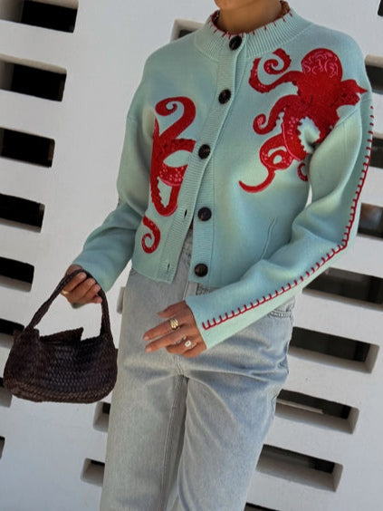 Detailed octopus print on a women's button-front cardigan. Long sleeves and unique style make it a great casual layer.