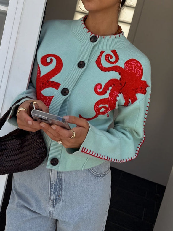 Women's fashion cardigan with an eye-catching octopus pattern, button-front, and long sleeves. A unique statement piece.