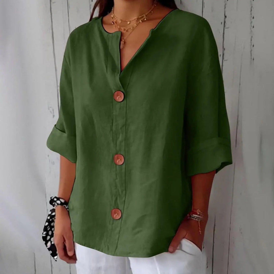 Model wearing a white women's linen button front blouse, three-quarter sleeves, styled for a relaxed summer look.