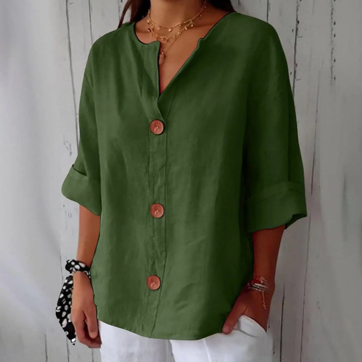 Model wearing a white women's linen button front blouse, three-quarter sleeves, styled for a relaxed summer look.