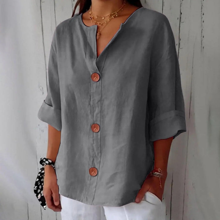 Elegant women's linen blouse, button front, three-quarter sleeves, ideal for spring & summer casual wear.