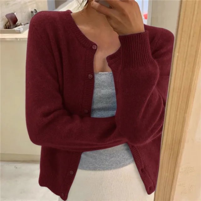 Classic women's button-front cardigan with a round neck, essential for versatile layering and warmth.