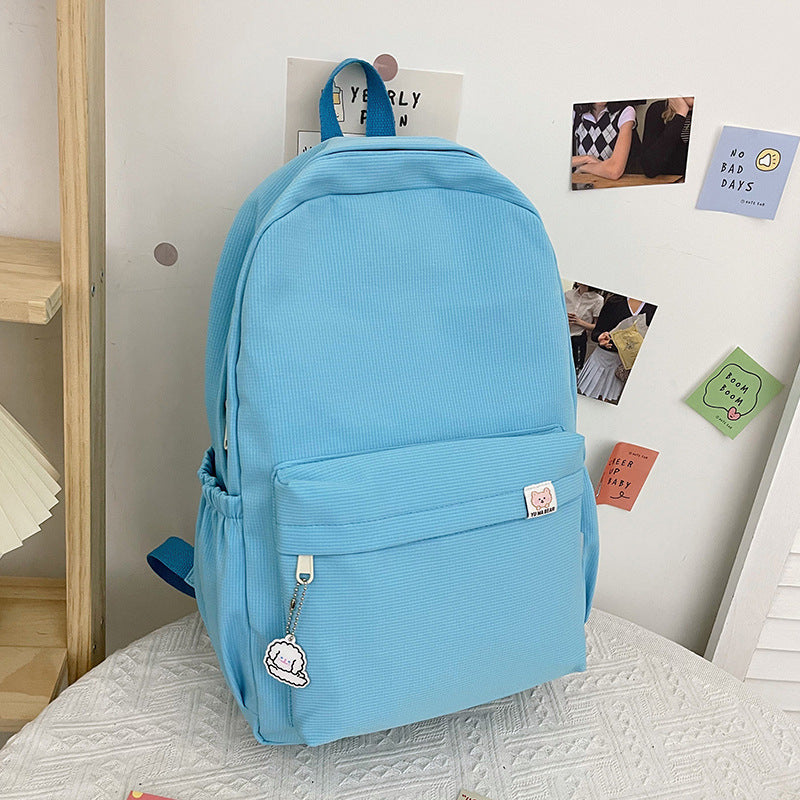 Versatile women's casual backpack, showcasing a chic ruffled texture, great for students & daily commuters.