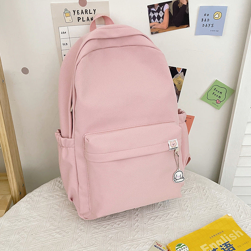 High-quality women's travel backpack in black, featuring an elegant ruffled texture and durable PU leather.