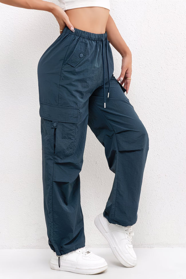 Relaxed fit women's cargo pants in a neutral tone, styled with a drawstring waist for casual summer outfits.