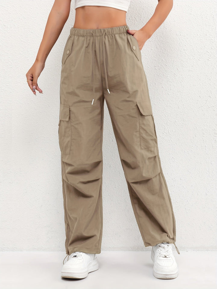 Modern women's relaxed fit cargo pants with an elastic drawstring waist and spacious utility pockets for casual chic.
