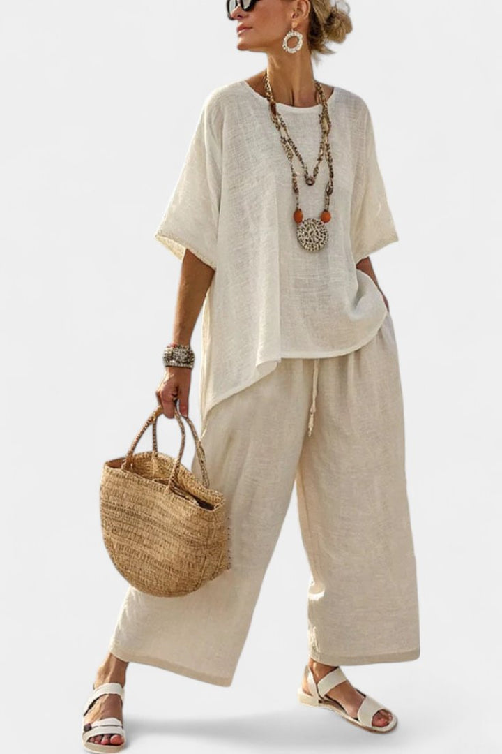Women's casual chic co-ord set with an asymmetric top & wide-leg trousers, perfect for summer vacation resort wear.