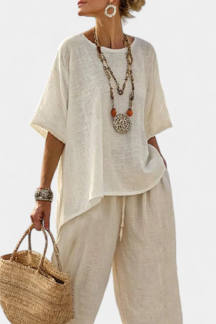 Versatile women's two-piece set featuring a stylish asymmetric top & comfortable wide-leg trousers for casual wear.