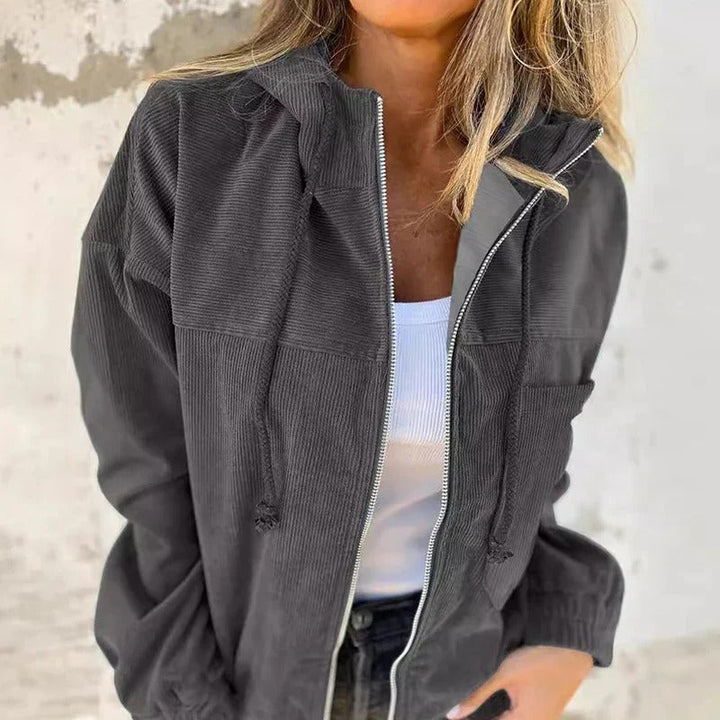 Detail of the comfortable hood and smooth zip-up closure on a women's lightweight casual jacket.