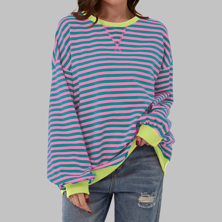 Woman in a relaxed fit long sleeve striped sweatshirt, showcasing a comfy, casual look.