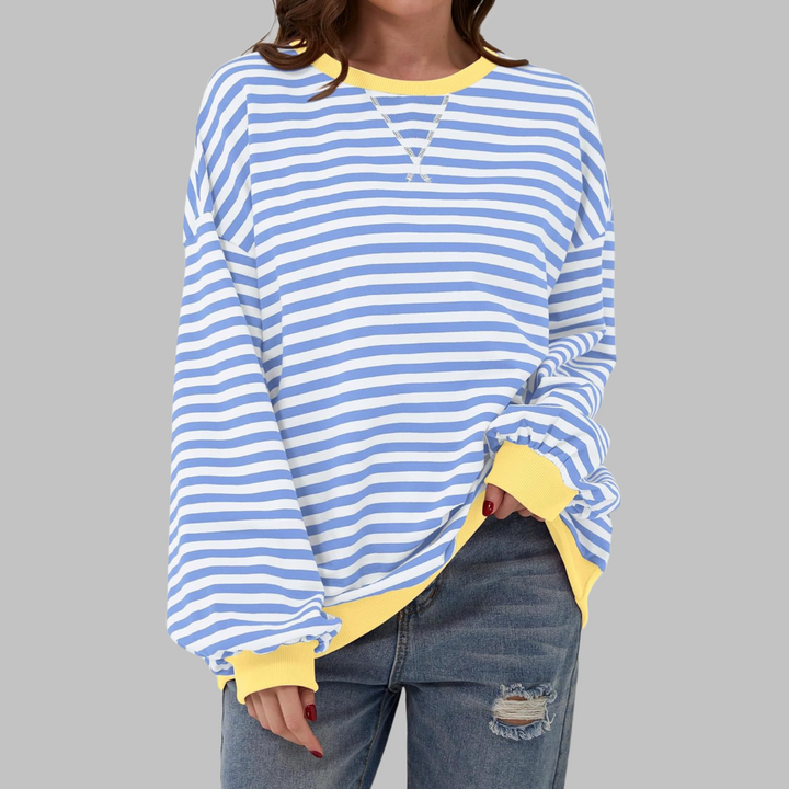 Close-up of soft striped fabric on a women's casual long sleeve round neck sweatshirt.