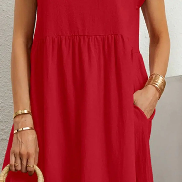 Woman models relaxed casual midi dress with pockets, perfect for effortless everyday style.