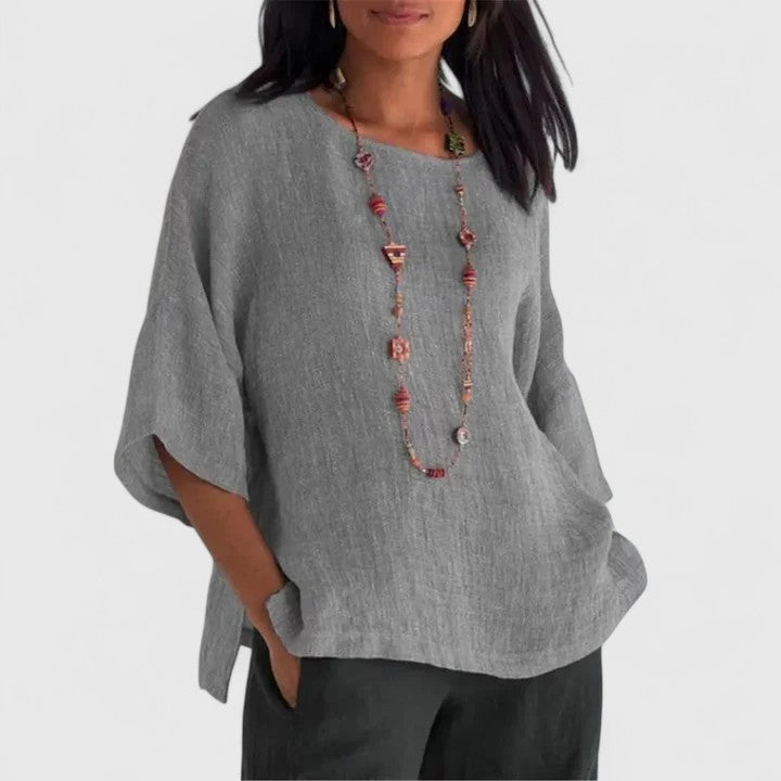 Women's casual O-neck tunic blouse with three-quarter sleeves, perfect for summer comfort and everyday wear.