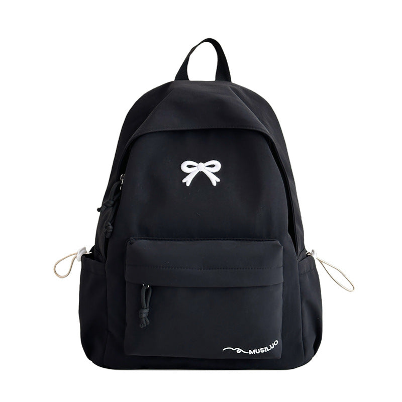 Fashionable bow-embossed women's school backpack, a cute and practical casual daypack for students.