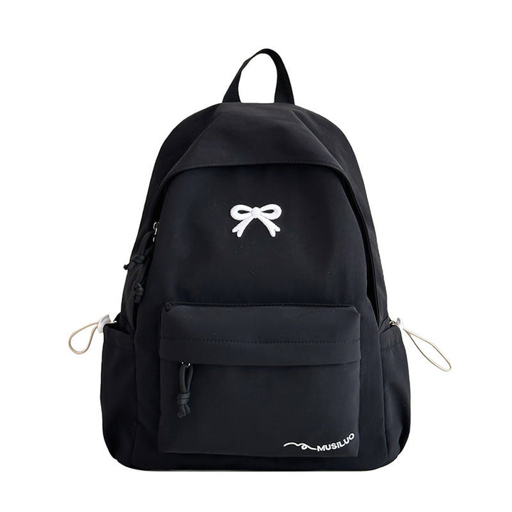 Fashionable bow-embossed women's school backpack, a cute and practical casual daypack for students.