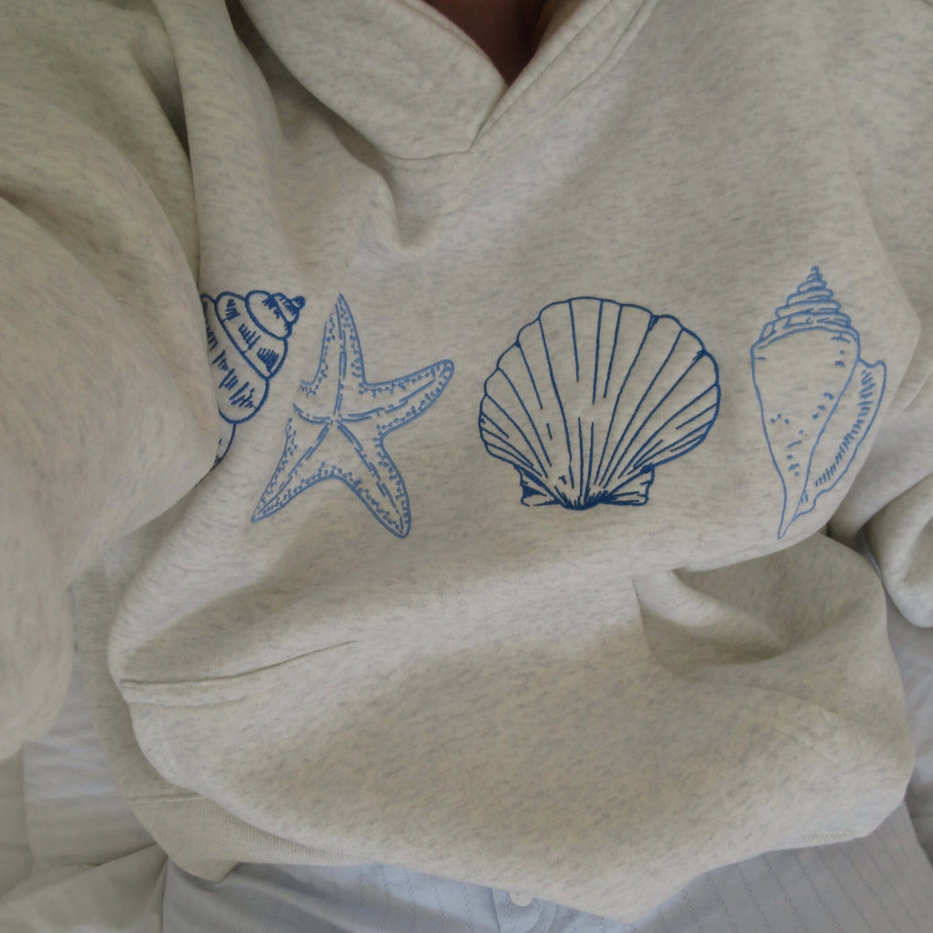 Women's casual seashell print hoodie, perfect for coastal everyday wear. Comfortable & relaxed fit.