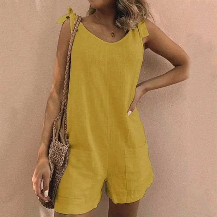 Stylish women's sleeveless short jumpsuit featuring charming bow-tie straps & convenient pockets.