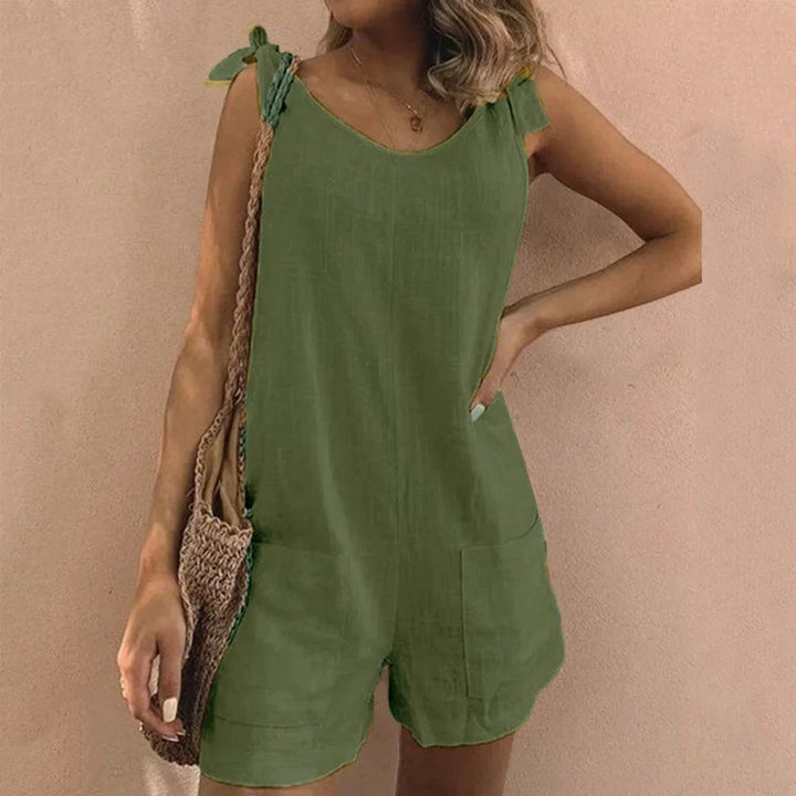 Chic women's short jumpsuit for summer fashion, featuring adjustable bow-tie straps and side pockets.