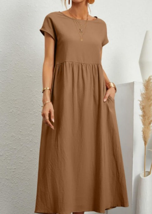 Modern women's summer midi dress, designed for comfort & versatility with short sleeves & functional pockets.