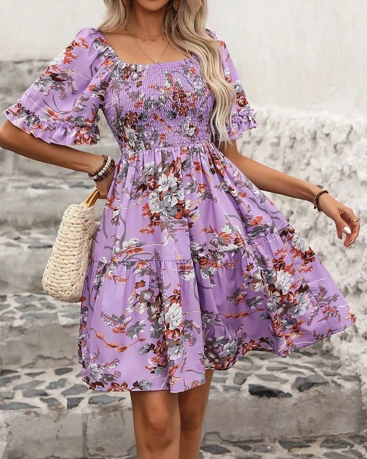 Women's charming floral smocked mini dress with puff sleeves, perfect for summer parties or casual wear.