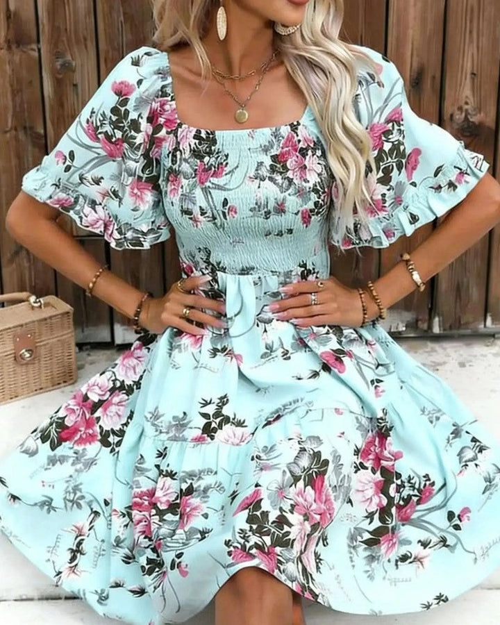 Vibrant floral smocked mini dress for women, boasting fashionable puff sleeves and a comfortable fit.