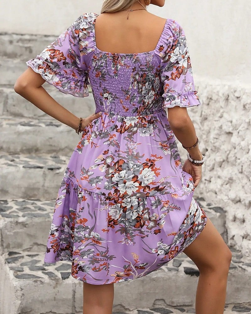 Stylish women's summer mini dress: colorful floral print, smocked bodice, and charming puff sleeves.