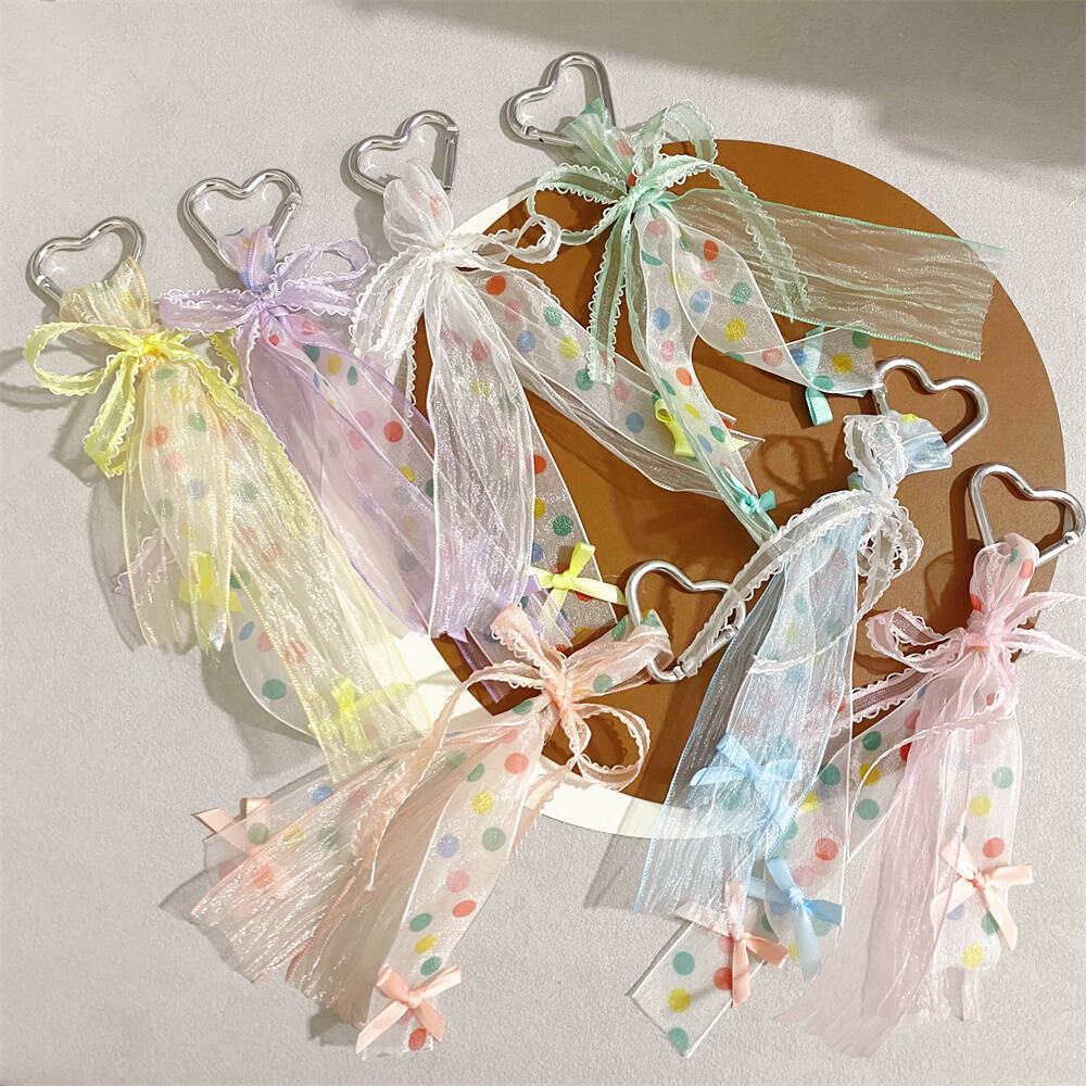 Women's charming heart keychain with a cute ribbon bow, perfect for bags or keys.