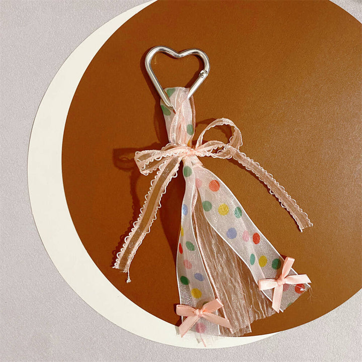 Adorable heart-shaped keychain with a sweet ribbon bow, a cute and colorful women's accessory.