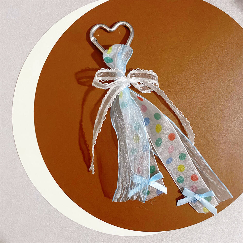 Women's charming heart keychain, vibrant ribbon bow, durable accessory, great gift or bag charm.