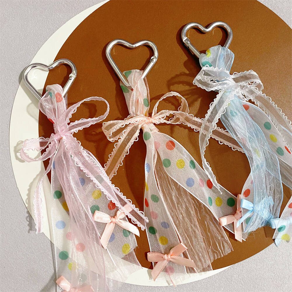 Colorful heart bag charm keychain with a playful ribbon bow, ideal accessory for women.