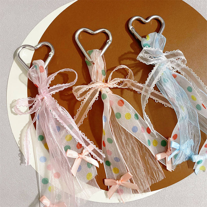 Colorful heart bag charm keychain with a playful ribbon bow, ideal accessory for women.