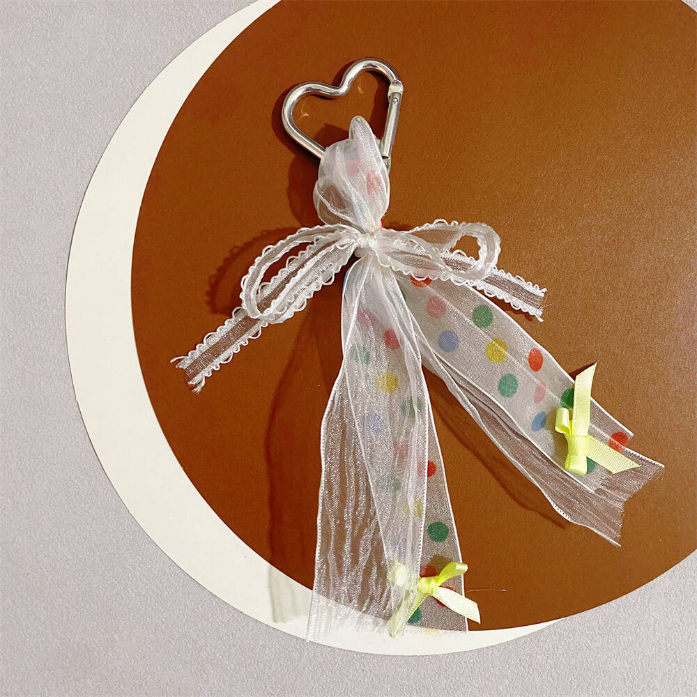 Assorted colorful heart keychains with ribbon bows, charming women's accessory and gift.