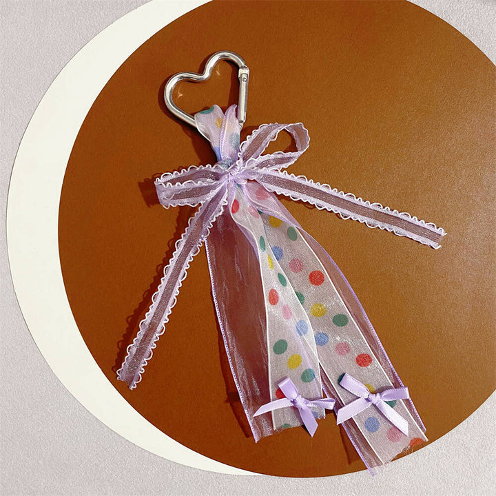 Charming heart accessory keychain with a ribbon bow, perfect for women's bags or keys.