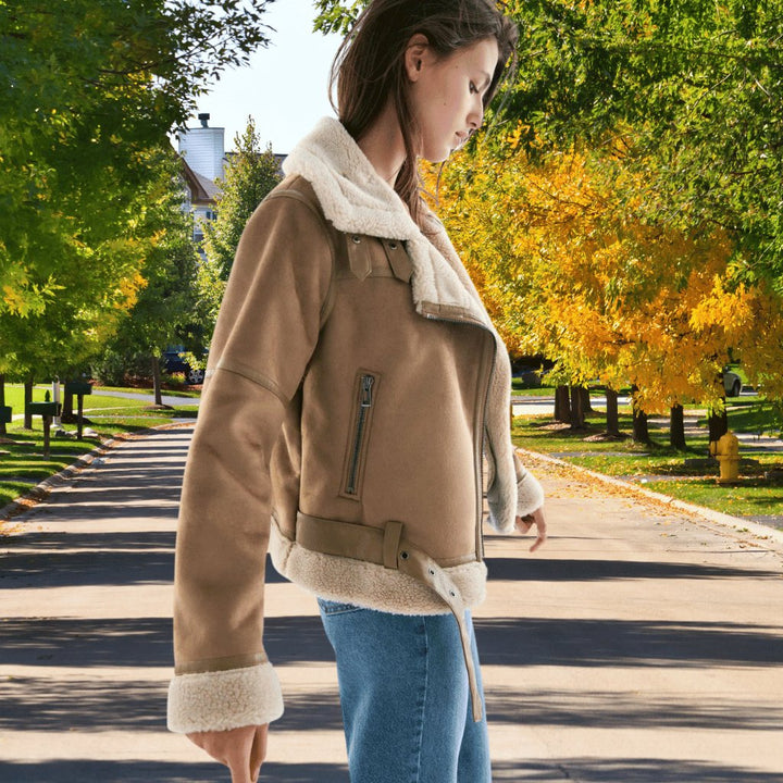 Detailed view of the collar and faux shearling lining of an aviator bomber fashion jacket.