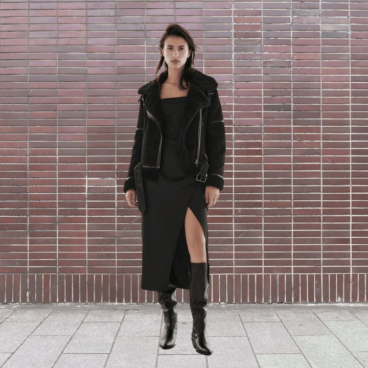 Model in an edgy women's bomber jacket, a bold statement piece for fashion-forward looks.